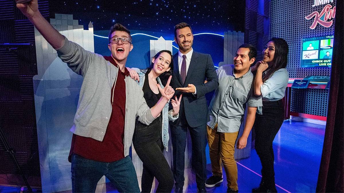 a group of people gets a picture with a celebrity